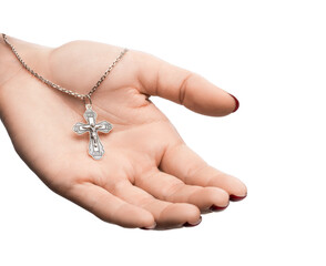 isolated on white background jewelry silver cross on a chain with a shadow lies on the hand of a girl model