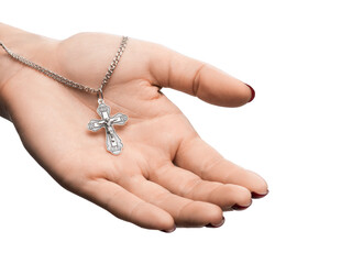 isolated on white background jewelry silver cross on a chain with a shadow lies on the hand of a girl model