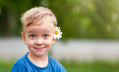 surprised boy with a daisy in his hair