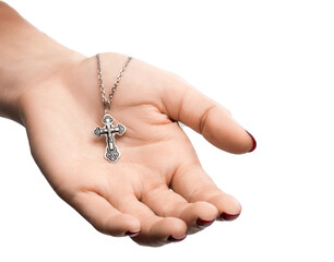 isolated on white background jewelry silver cross on a chain with a shadow lies on the hand of a girl model