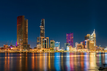 Fototapeta na wymiar Ho Chi Minh City skyline and the Saigon River at night. Amazing colorful view of skyscraper and other modern buildings. Travel concept