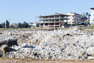 multi-storey building construction blue sky and stones and rubble spilled on land