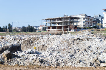 multi-storey building construction blue sky and stones and rubble spilled on land