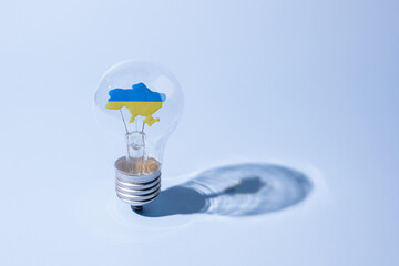 The glass bulb lamp with a yellow-blue Ukrainian map inside. Strong concept of Ukrainians