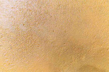 Yellow wall texture is rough and patchy