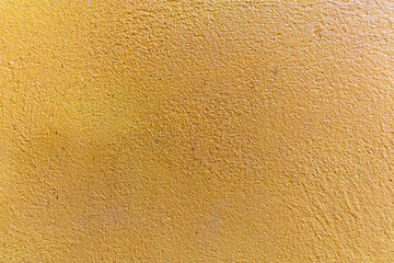 Yellow wall texture is rough and patchy