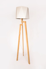 Wooden tripod lamp. Minimalist lamp and lighting design for home interior.