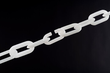 White plastic chain on black background
