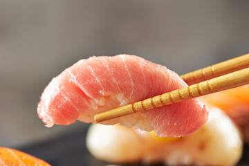 Tuna sushi on chopsticks