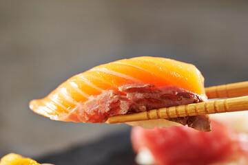 Salmon sushi on chopsticks