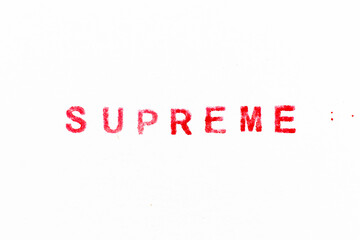 Red color ink rubber stamp in word supreme on white paper background