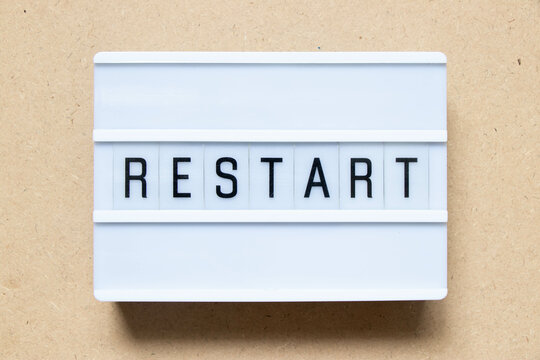 Lightbox with word restart on wood background