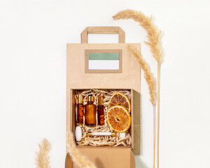 Cardboard gift box with self care set with natural cosmetic and paper bag for packaging goods from online store and delivery. Eco friendly packaging concept. Ecologic craft package. Flat lay