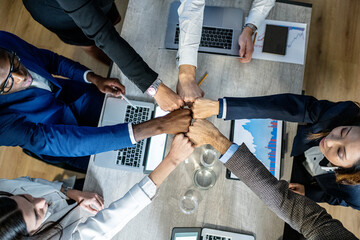 Fist bumb greeting and congratulations on the excellent teamwork, international business team colleagues