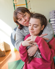 a girl diagnosed with autism with her mother in a rehabilitation center.