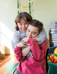a girl diagnosed with autism with her mother in a rehabilitation center.