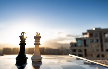 Fototapeta premium Two chess kings on city background