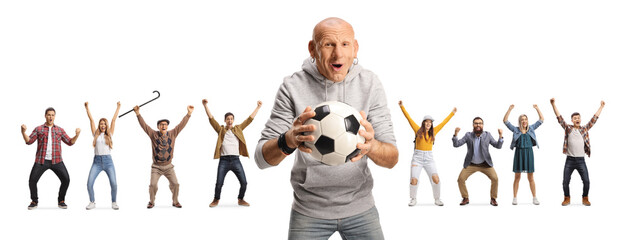 Bald cheerful man holding a football and people cheering in the back