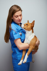 Veterinarian doctor woman holding dog on hands.Isolated portrait of female medical worker with animal.