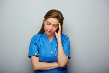 Thinking doctor or nurse in medical suit. Isolated portrait. - 555668426
