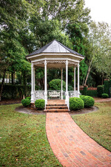 A small gazebo with a brick pathway