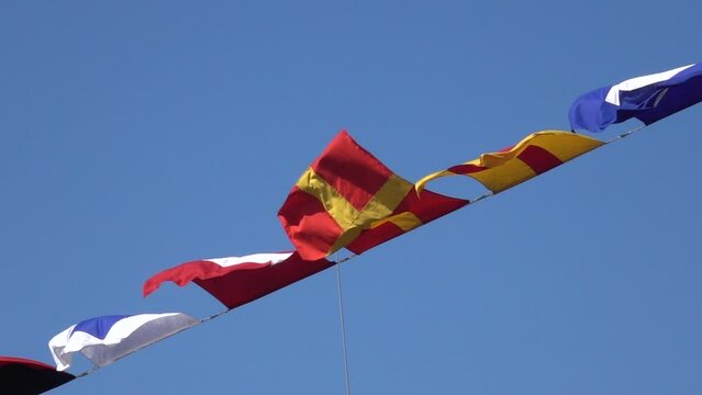 Various nautical flags tied together with rope, Ship flags signals, morse code,