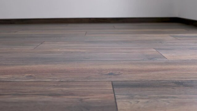 New laminate flooring. Laminated parquet with brown wooden texture