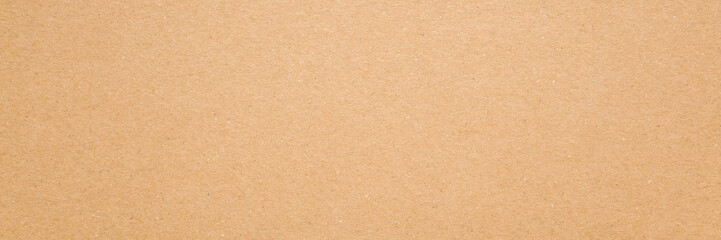 Light brown carton background. Closeup. Material for products packaging. Wide banner. Empty place...