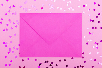 Pink mail envelope and heart-shaped sequins on a pink background. The concept of Valentine's day, love, dating and wedding. copy space, background for design