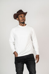 An african man with blank white shirt doing a pose while facing sideways at the white background