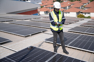 Portrait African American engineer man smiling working with solar panel on roof factory