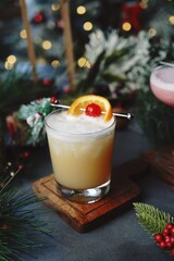 New year cocktail Whisky Sour on festive holiday bokeh background