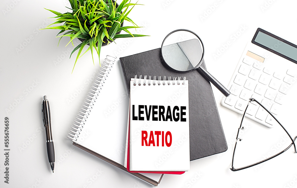 Poster text leverage ratio on notebook with office tools on white background