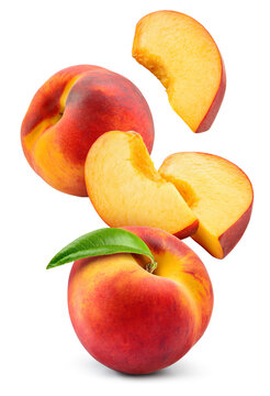 Peach isolated. Whole peach flying with a slice on white background. Falling peach fruit with leaf and cut pieces. Full depth of field.