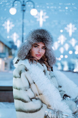Outdoor close up portrait of young beautiful happy smiling girl with red lips, wearing in a fur...
