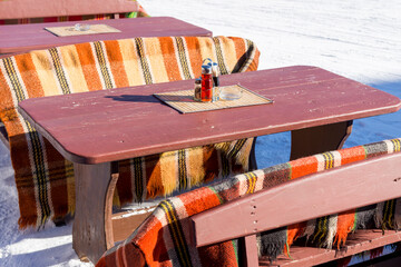 Outdoor restaurant tables in a snowy winter landscape, Pamporovo, Bulgaria.