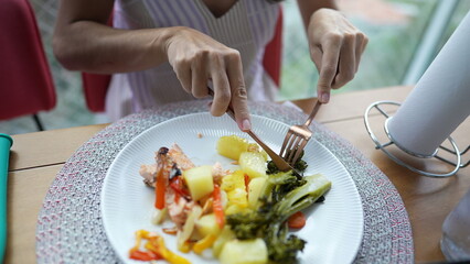 Woman eating healthy food on plate. Person eats vegetables organic meal for lunch time
