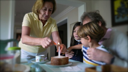 Obraz na płótnie Canvas Family celebrating birthday with one candle. grandparents with grandchildren celebrate anniversary