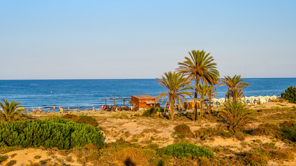 Elche beach in the golden dusk light. Landscape and scenic in the famous place and tourist attraction, Spain