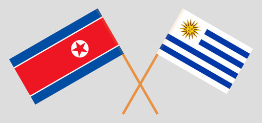 Crossed flags of North Korea and Uruguay. Official colors. Correct proportion