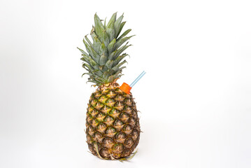 Pineapple, fruit on a white background, with a straw in the spout to be able to drink like a juice bottle, close-up.