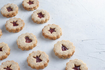 Christmas cookies, Linzer cookies on the light background, different motifs.