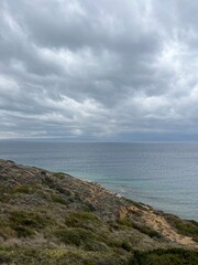 Cloudy sea view, dark clouds at the sea, rocky coast