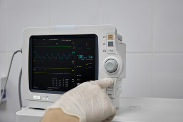 Monitor screen of the device for tracking the pulse and pressure of the patient, close-up. Doctor...