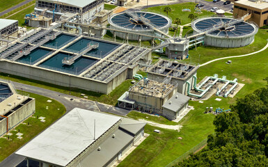 Aerial view of modern water cleaning facility at urban wastewater treatment plant. Purification process of removing undesirable chemicals, suspended solids and gases from contaminated liquid