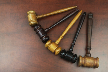 Close up of different judge gavel on wooden table. Different laws, courts and legal systems concept.
