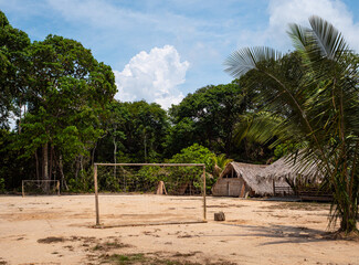 A crude football pitch with goalposts is still essential for the indigenous Tatuyo tribe in their jungle village on the edge of the Amazon rainforest near Manaus, Brazil. © Graham King