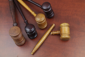 Broken judge gavel and whole wooden judge gavels on table. Lawlessness, changing in laws and court concept.