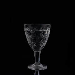 vintage crystal shot glass of vodka on black background