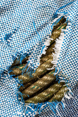 Old rope seen through torn tarpaulin